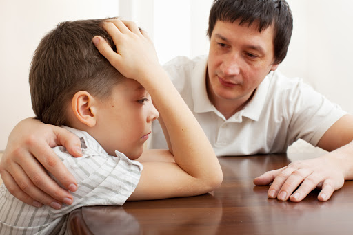Father comforts a sad child. Problems in the family &#8211; pt