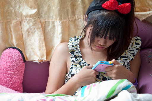 asian girl play mobile phone &#8211; pt
