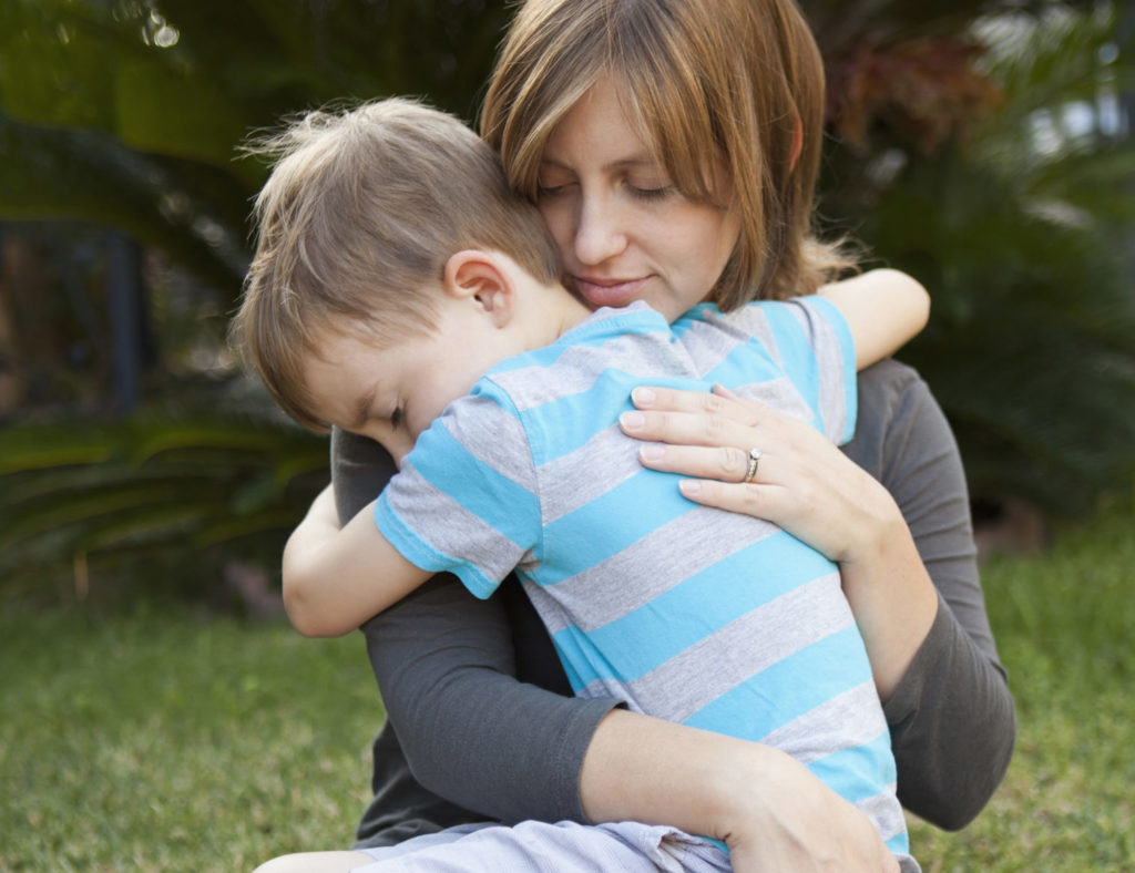 USA, California, Los Angeles, Mother hugging her son.