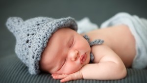 Sleeping newborn baby on a blanket