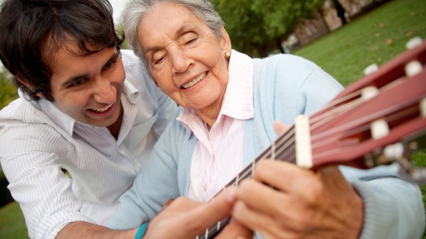 web-old-grandma-grandson-teaching-play-woman-playing-guitar-shutterstock_62314828-esb-professional-ai