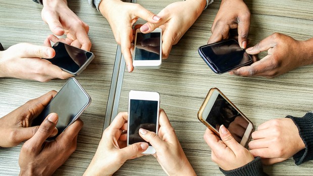 web3-hands-smartphones-table-desk-disobeyart-shutterstock