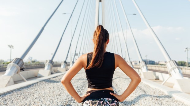 Attractive sporty woman on the bridge