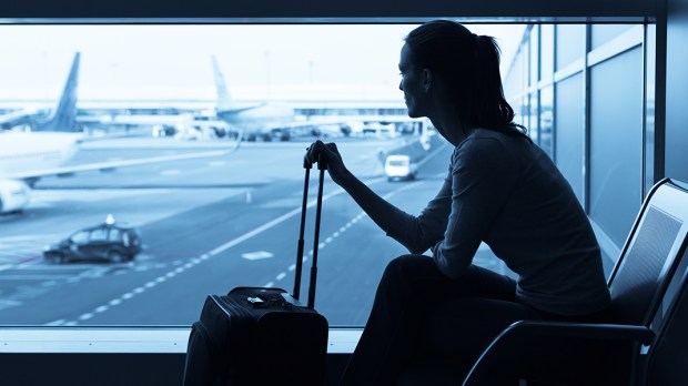 HERO-AIRPORT-WOMAN-WINDOW-KieferPix-Shutterstock_254786722