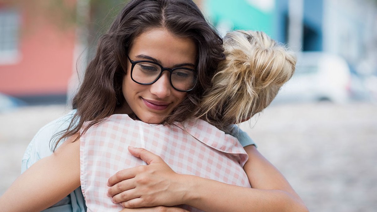 hero-young-woman-embrace-hug-freindship-mercy-care-wavebreakmedia-shutterstock_411947671