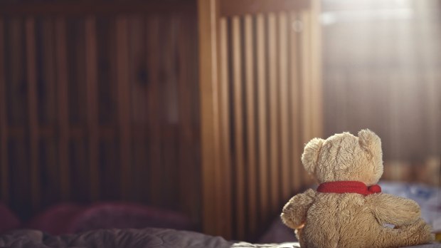 web-empty-crib-teddy-bear-lonely-ambrozinio-shutterstock_472411414