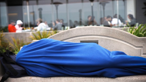 web-homeless-man-blue-blanket-bench-sleeping-nathan-rupert-cc
