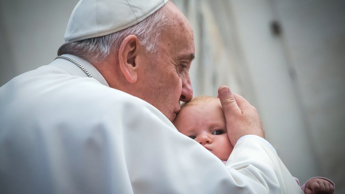 Topshots – Pope Francis kisses a baby as he arrives for his week