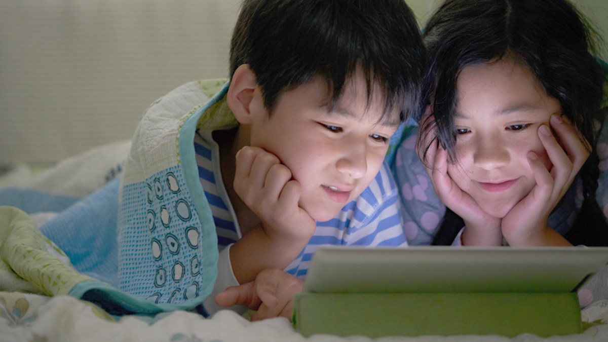 WEB3 CHILDREN BED IPAD TABLET BOY GIRL ASIAN KIDS NIGHT MOVIE Shutterstock