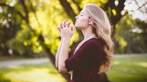 WEB3-PRAY-WOMAN-SUN-OUTDOORS-FAITH-HANDS-PRAYING-Ben-White-Unsplash