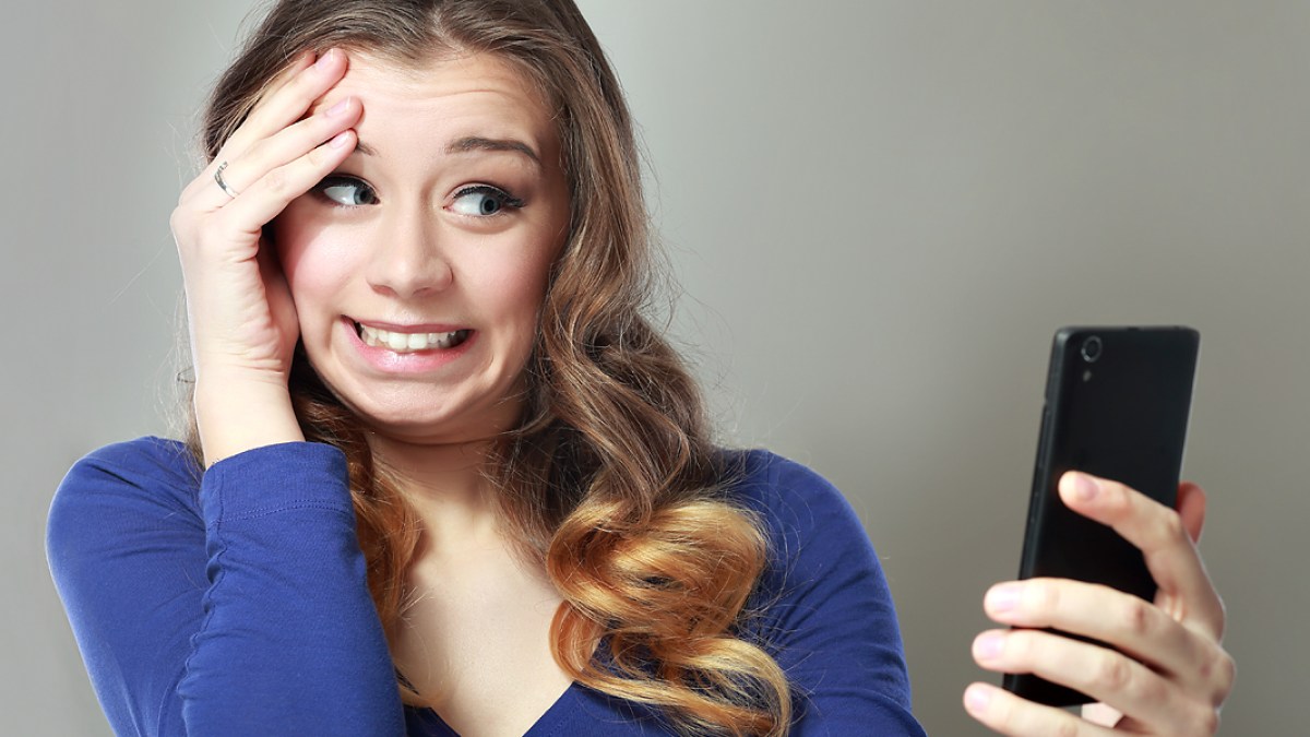 WEB3 YOUNG WOMAN BLUE PHONE ADDICTED Shutterstock