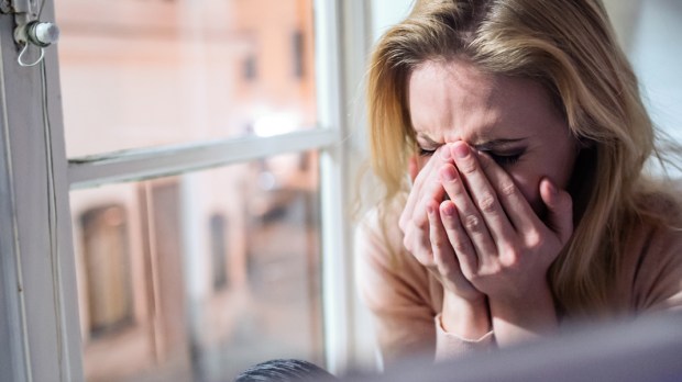WEB3 WOMAN CRYING SAD WINDOWSILL DEPRESSED Shutterstock