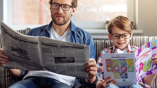 WEB3-DAD-SON-CHILD-MAN-NEWSPAPER-READING-GLASSES-Shutterstock