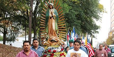 Members of the Cathedral of St. Peter the Apostle process with the statue of the