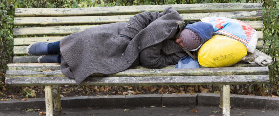 Homeless man sleeping on a bench