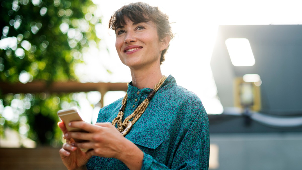 Businesswoman standing and using mobile phone