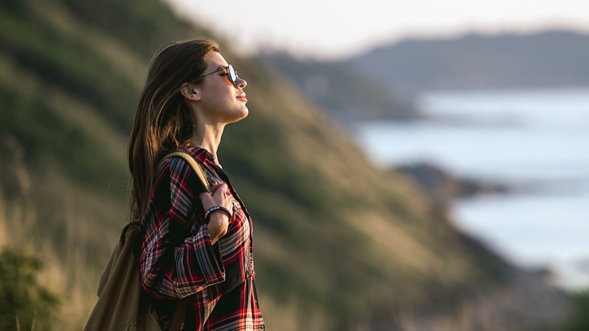 web3-woman-hiking-nature-field-water-ocean-shutterstock