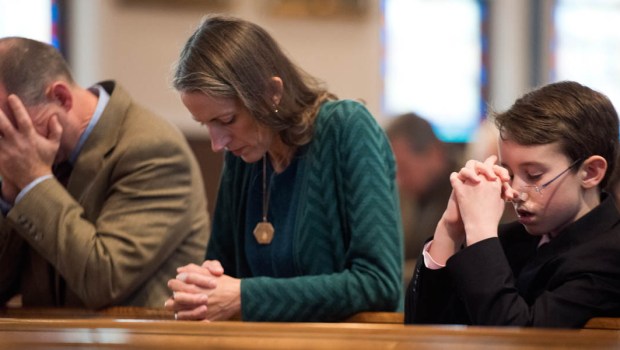 PEOPLE PRAYING IN CHURCH