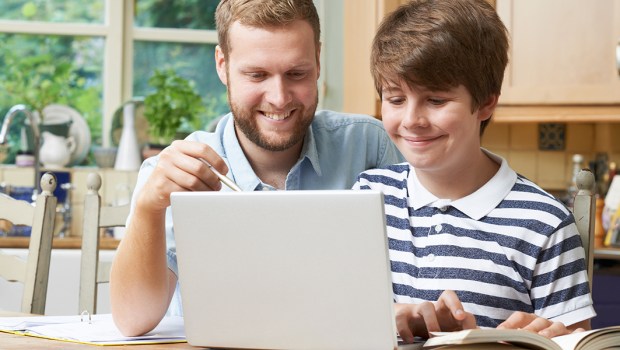 Tutor Helping Teenage Boy With Studies