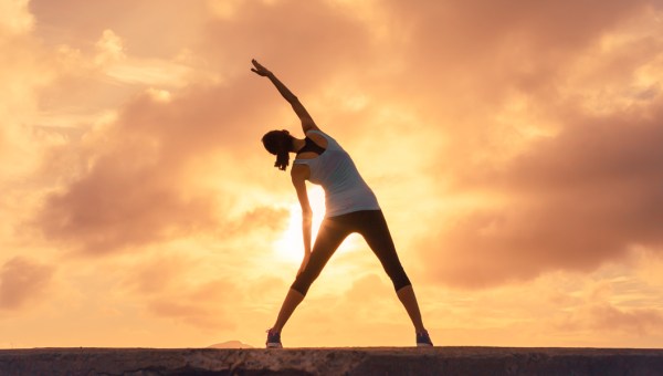 WOMAN,STRETCHING,SUNSET