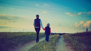 WOMAN CHILD WALKING ON PATH