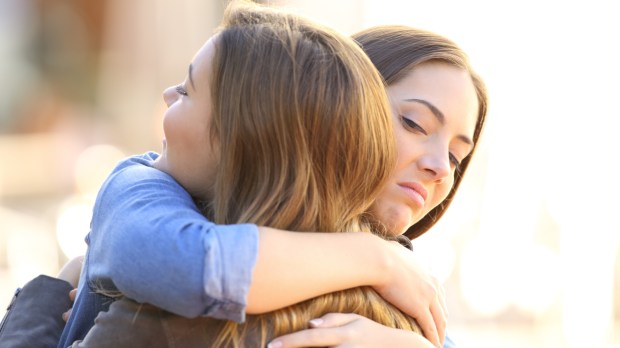 web2-hypocritical-girl-embracing-a-friend-outdoors-in-the-street-shutterstock_552708262.jpg