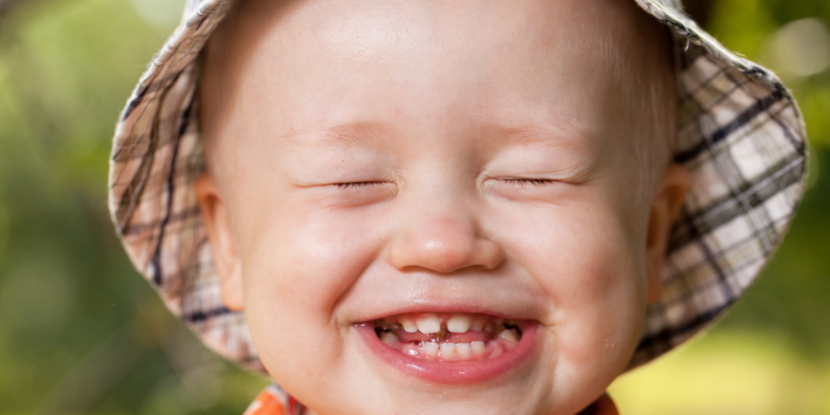 child smiles with teeth