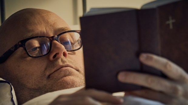 web3-middle-aged-man-reading-bible-on-bed-shutterstock_587738669.jpg