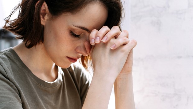 WOMAN PRAYS,