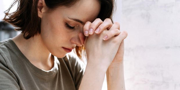 WOMAN PRAYS,