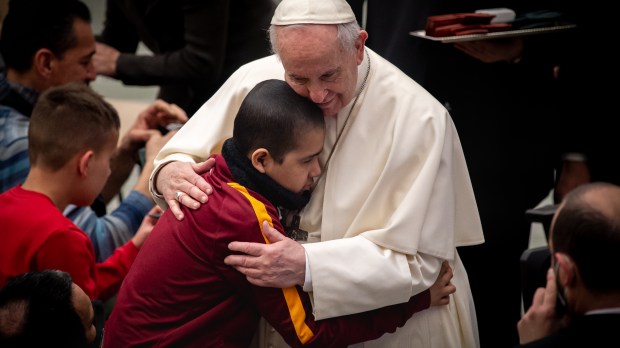 Pope Francis hugs a child