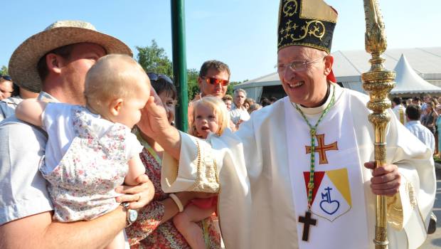 A Catholic bishop blesses a child