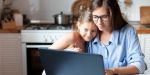 Mother and daughter using laptop