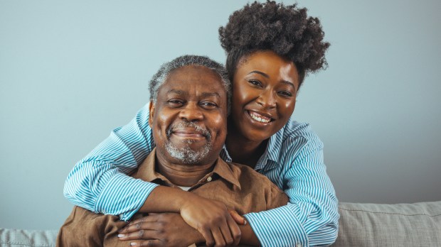 Portrait of father and daughter laughing and being happy.