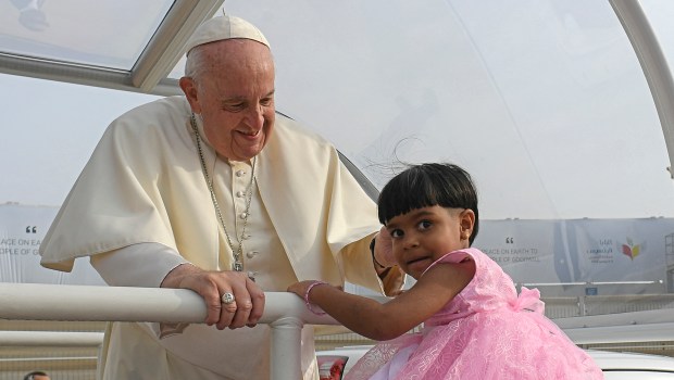 Pope-Francis-blessing-a-child-as-he-arrives-to-celebrate-mass-at-Bahrain-National-Stadium-in-Riffa-AFP