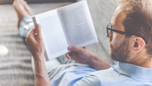 Man reading book at home