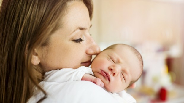 young mom holding newborn