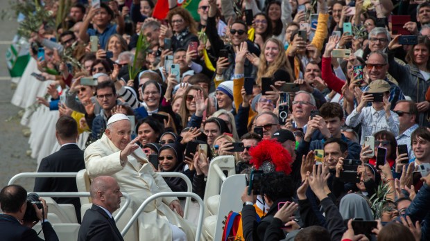 Pope Francis blesses the faithful at the end of Palm Sunday Mass in St. Peter's Square