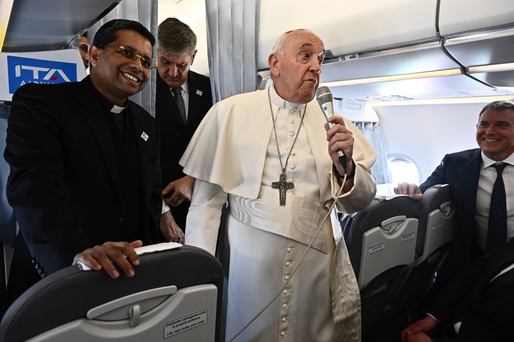 Pope Francis speaks with journalists during his flight from Rome Fiumicino International Airport to Budapest International Airport on April 28, 2023