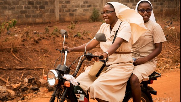 Two nuns on a motorcycle in Togo. This is how they get around to do their pastoral activity