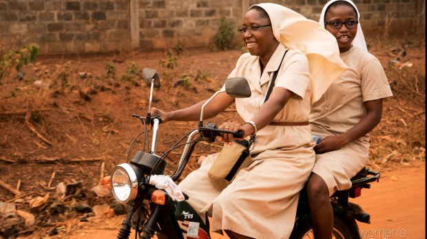 Two nuns on a motorcycle in Togo. This is how they get around to do their pastoral activity