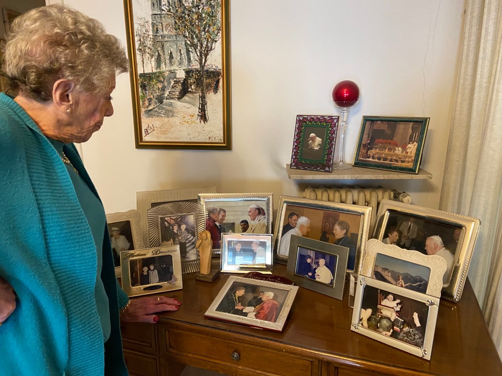 Joan Lewis, a Veteran Vatican journalist, showing her collection of photos