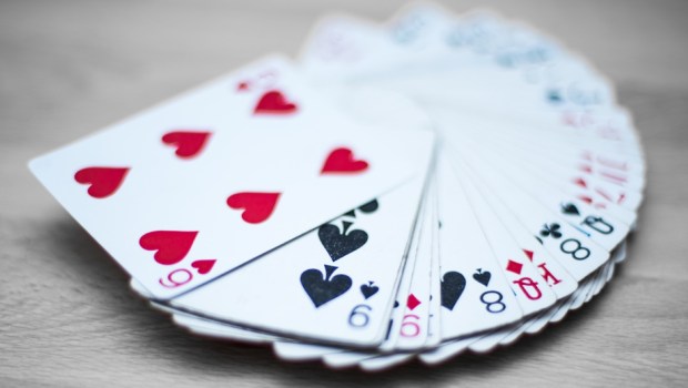 Playing cards deck isolated on a gray wooden background