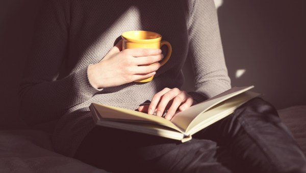 woman hands coffee reading dark