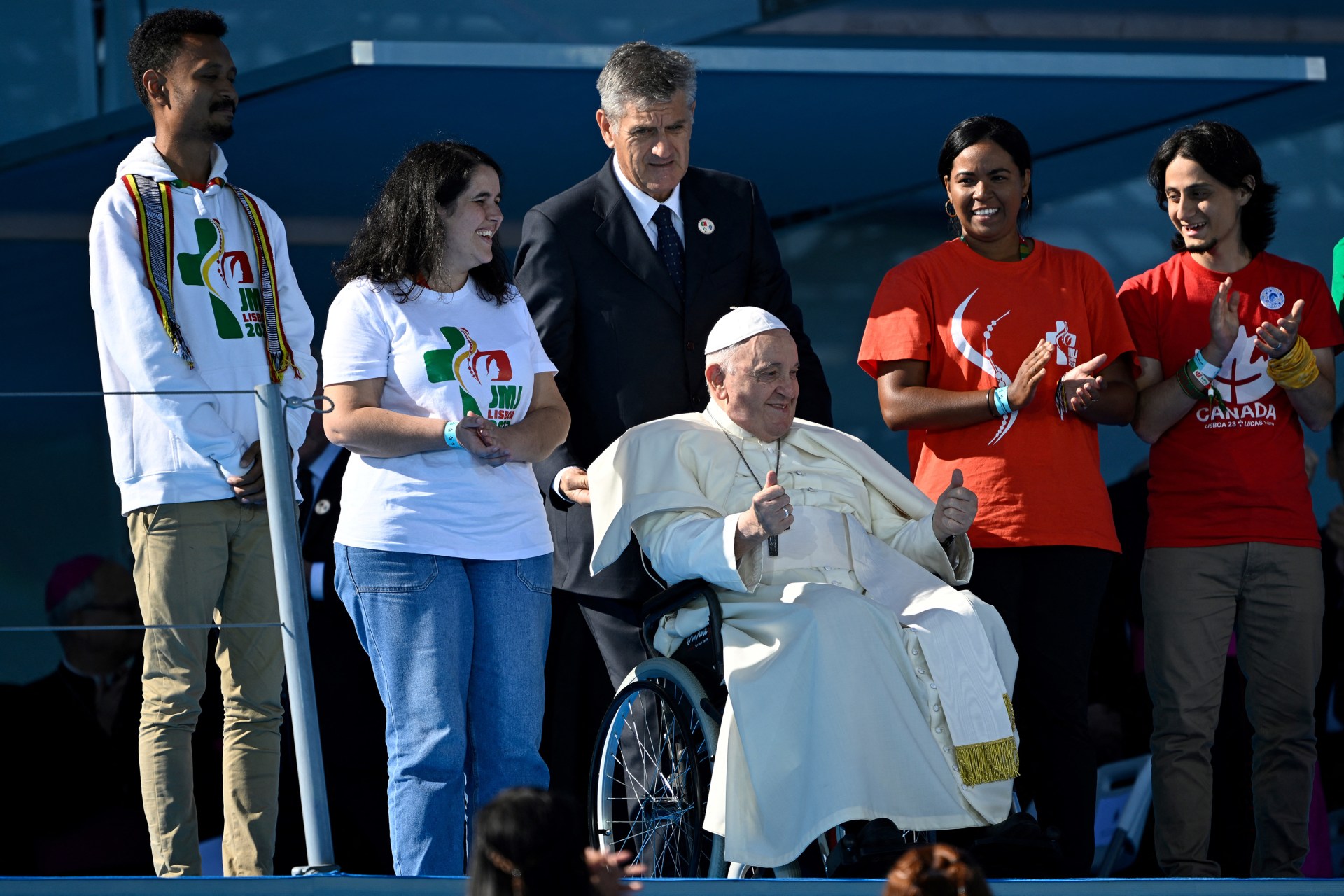 Pope Francis gestures as he arrives onstage during the welcoming ceremony of World Youth Day