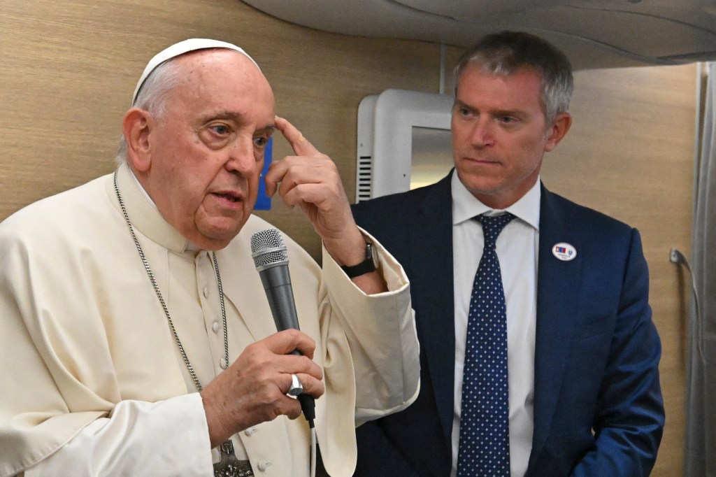 Pope Francis addresses journalists aboard the Papal plane heading to Mongolia on August 31, 2023