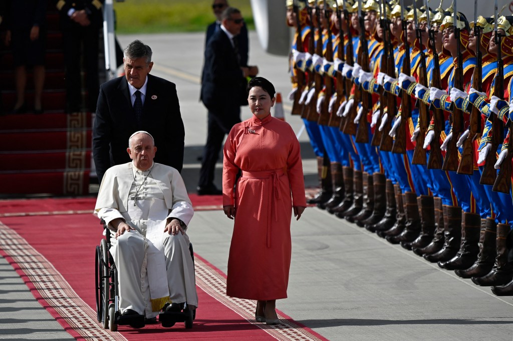 Pope Francis is received by Mongolia's Minister of Foreign Affairs Batmunkh Battsetseg during his arrival at Chinggis Khaan International Airport in Ulaanbaatar