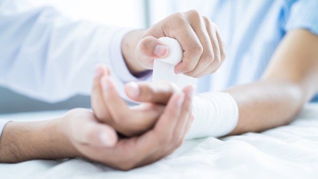 Médico fazendo curativo em paciente