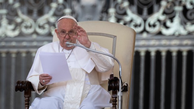 Pope Francis waves to the crowd during his speech at his weekly general audience on May 15, 2024