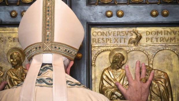 Pope Francis opens the Holy Door at St Peter's basilica to mark the start of the Jubilee Year of Mercy, on December 8, 2015 in Vatican.